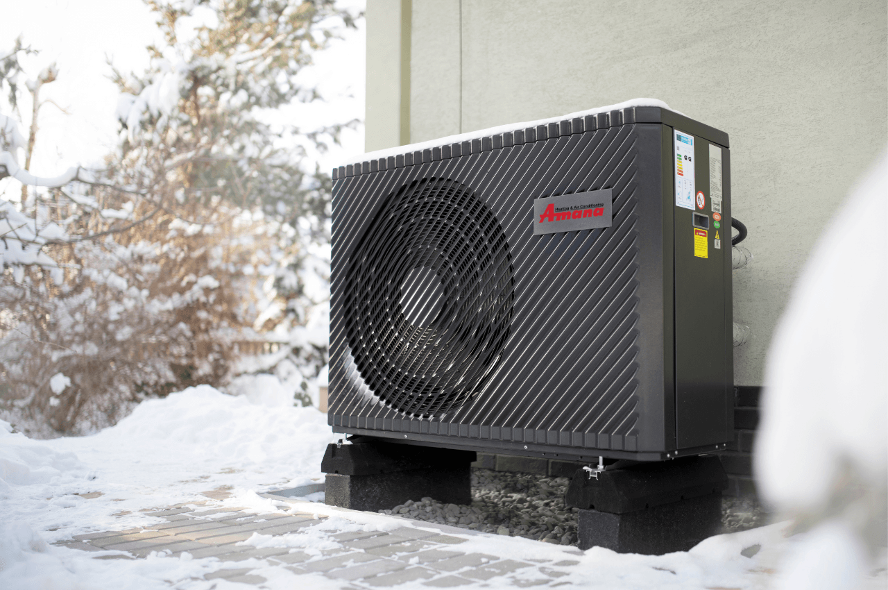 Heat pump unit outside with snow on the ground
