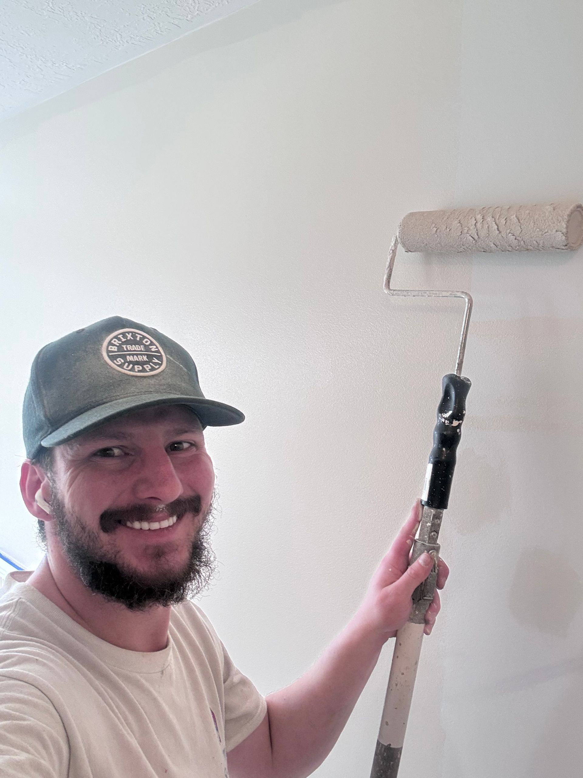 Painter rolling a clean interior wall